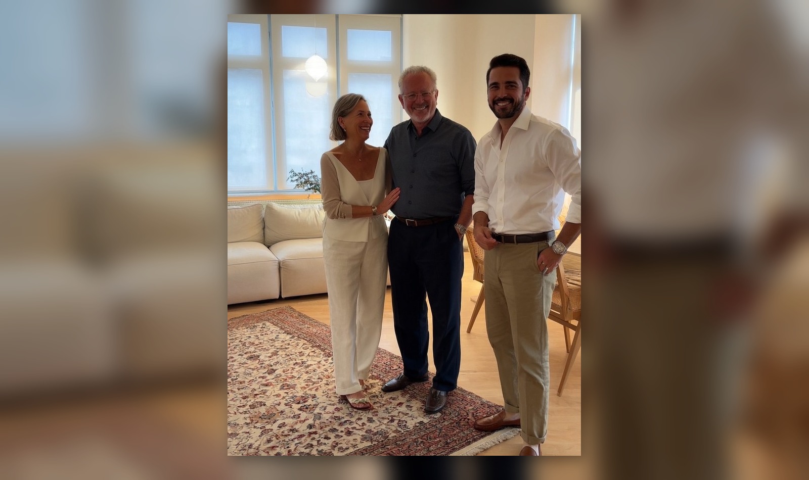Clients standing with a rug in a bright room